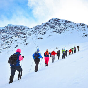 Team on hike in snow in mountains